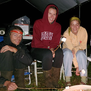 Team members gathering around a campfire during a power outage